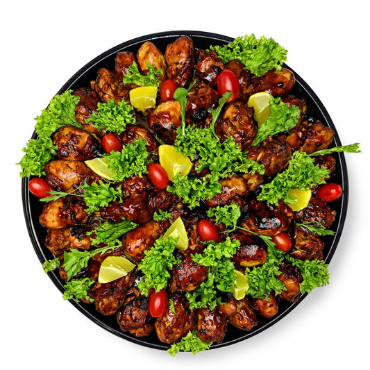 The Drumstick Platter with glazed chicken drumsticks, parsley garnish and lime wedges
