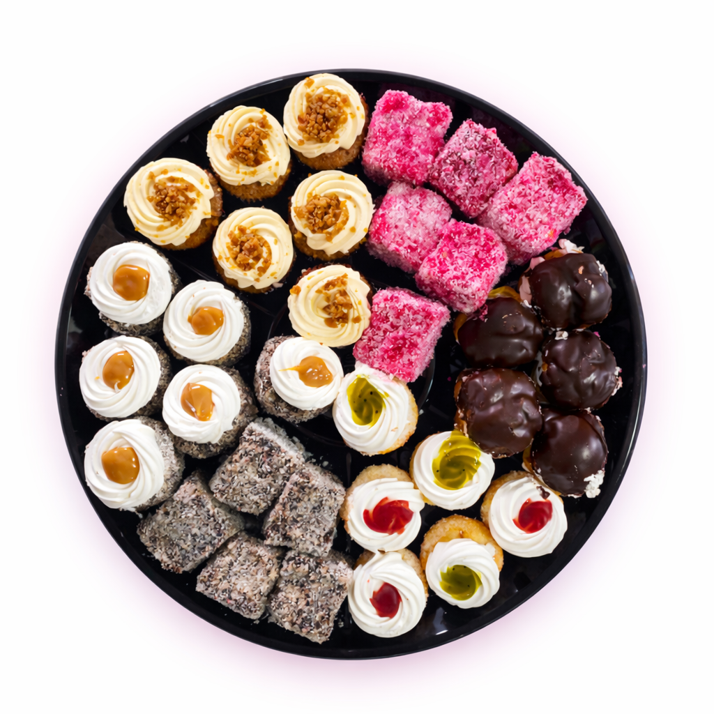 Assorted dessert platter with pink bars, chocolate bites, and mini cream pastries