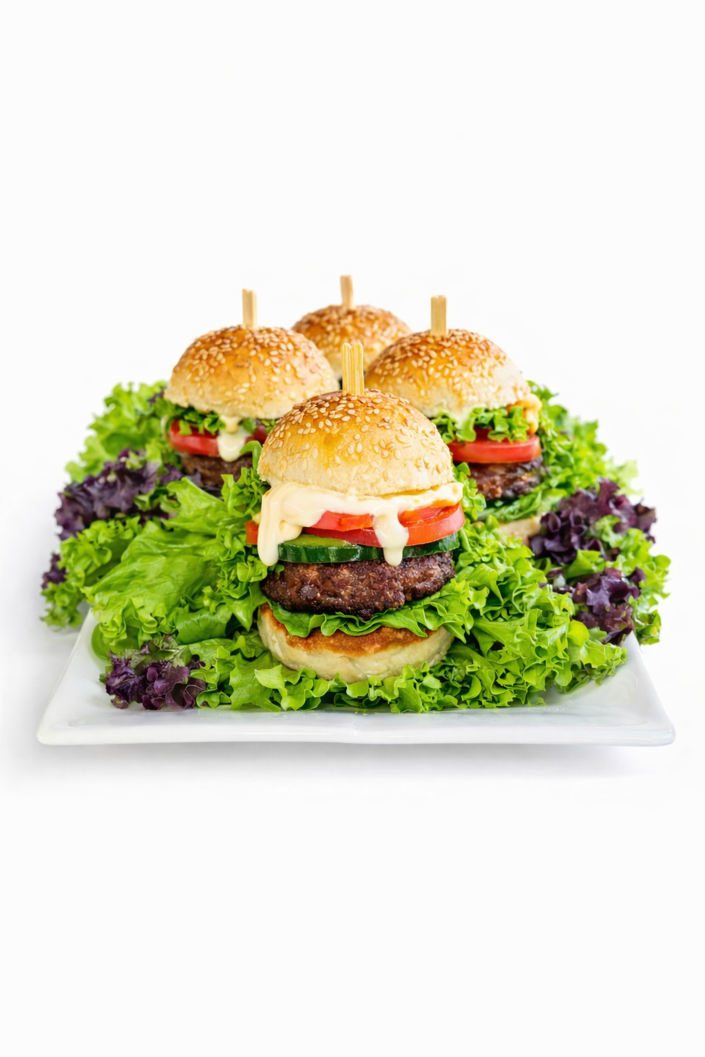 Beef sliders with sesame buns, beef patties, lettuce, tomato and sauces
